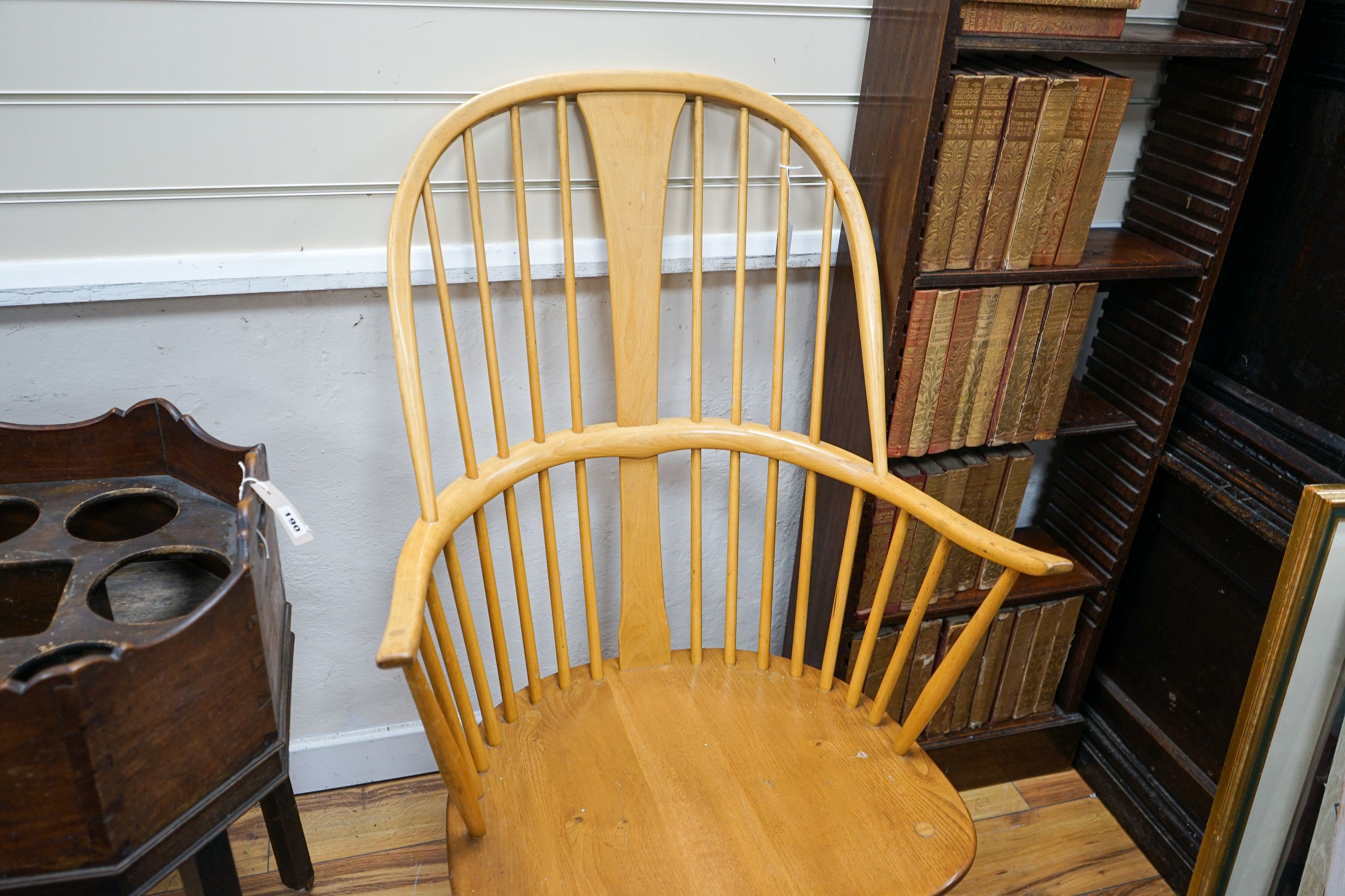 An Ercol light elm and beech comb back Windsor armchair